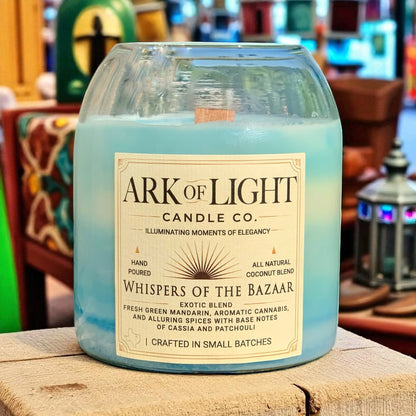 Candle with 'ARK OF LIGHT CANDLE CO.' label on a wooden surface